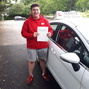 Young man holding test certificate in Chesterfield.
