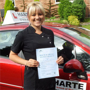 Happy young woman holding first time pass certificate in Chesterfield